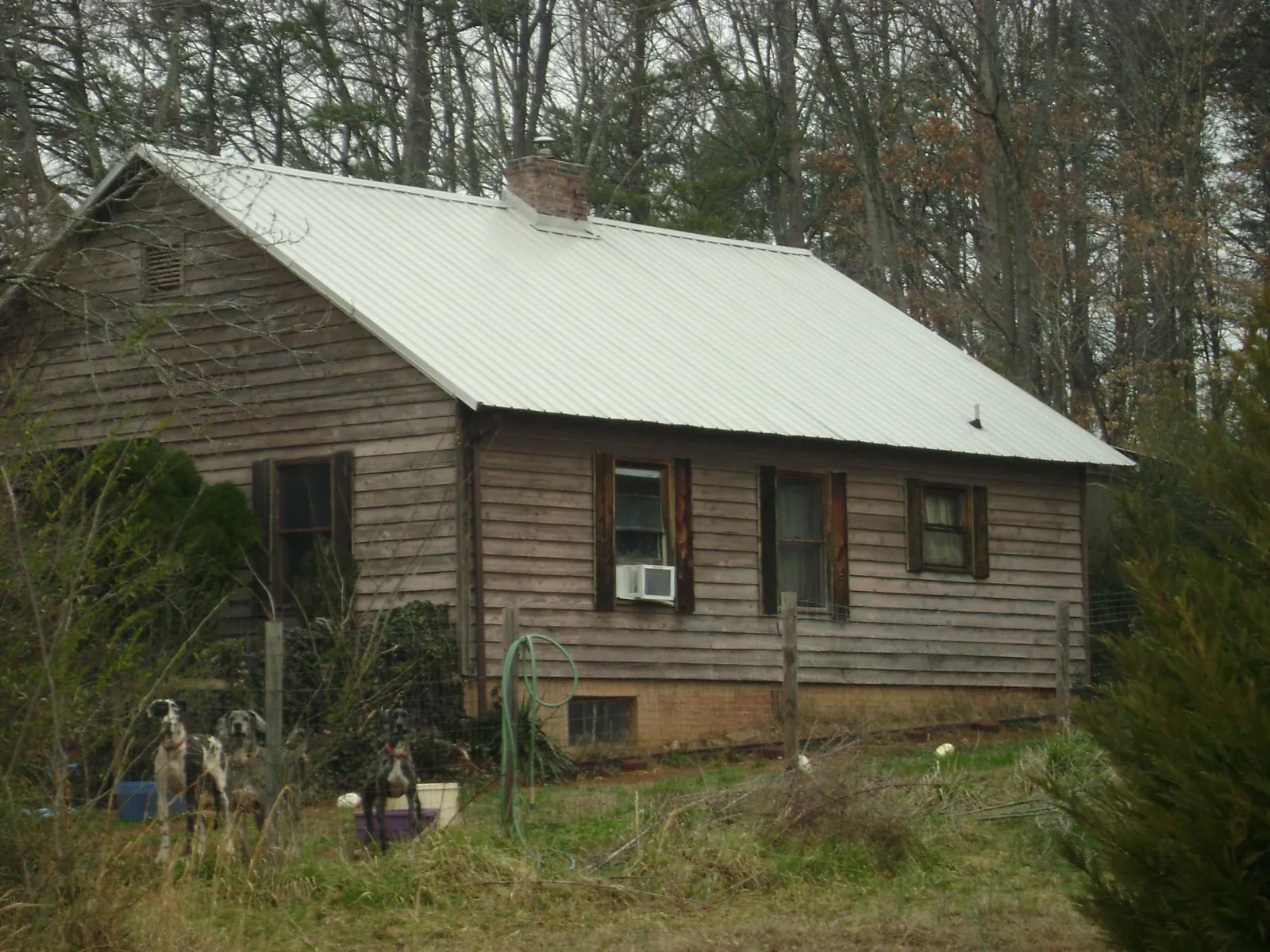 White metal roof on an old wood sided farmhouse, from a Metal Roof Installation job in Haymarket